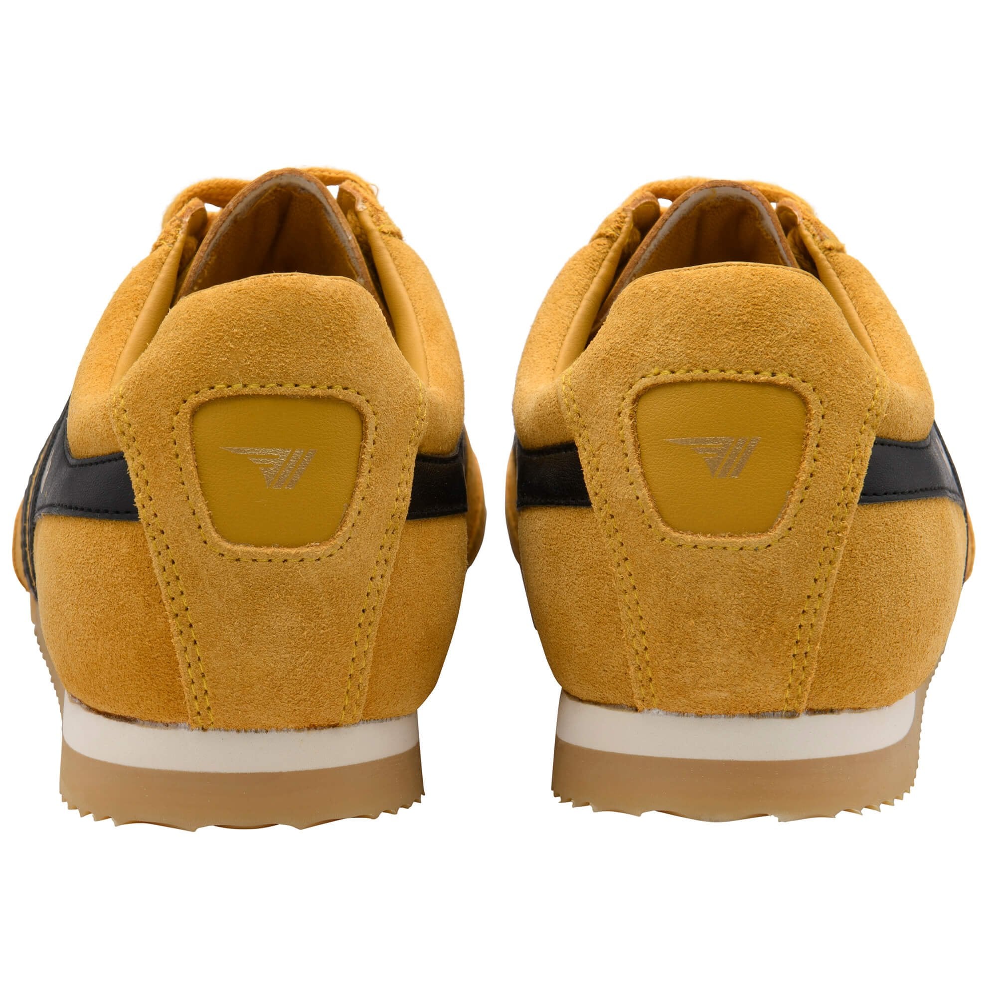 Pair of yellow trainers with Gola logo on the back on a white background