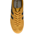 Top-down view of a mustard yellow Gola sneaker with black stripes and laces