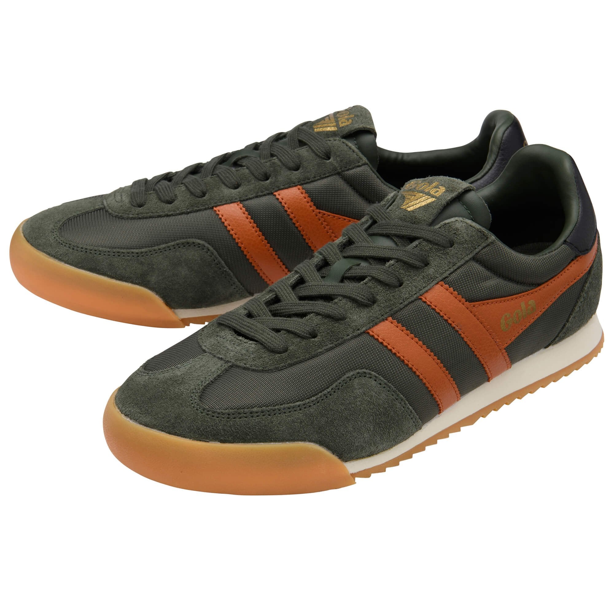 Green and orange trainers with striped design on a white background
