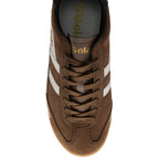 Brown trainer with white stripes on a white background