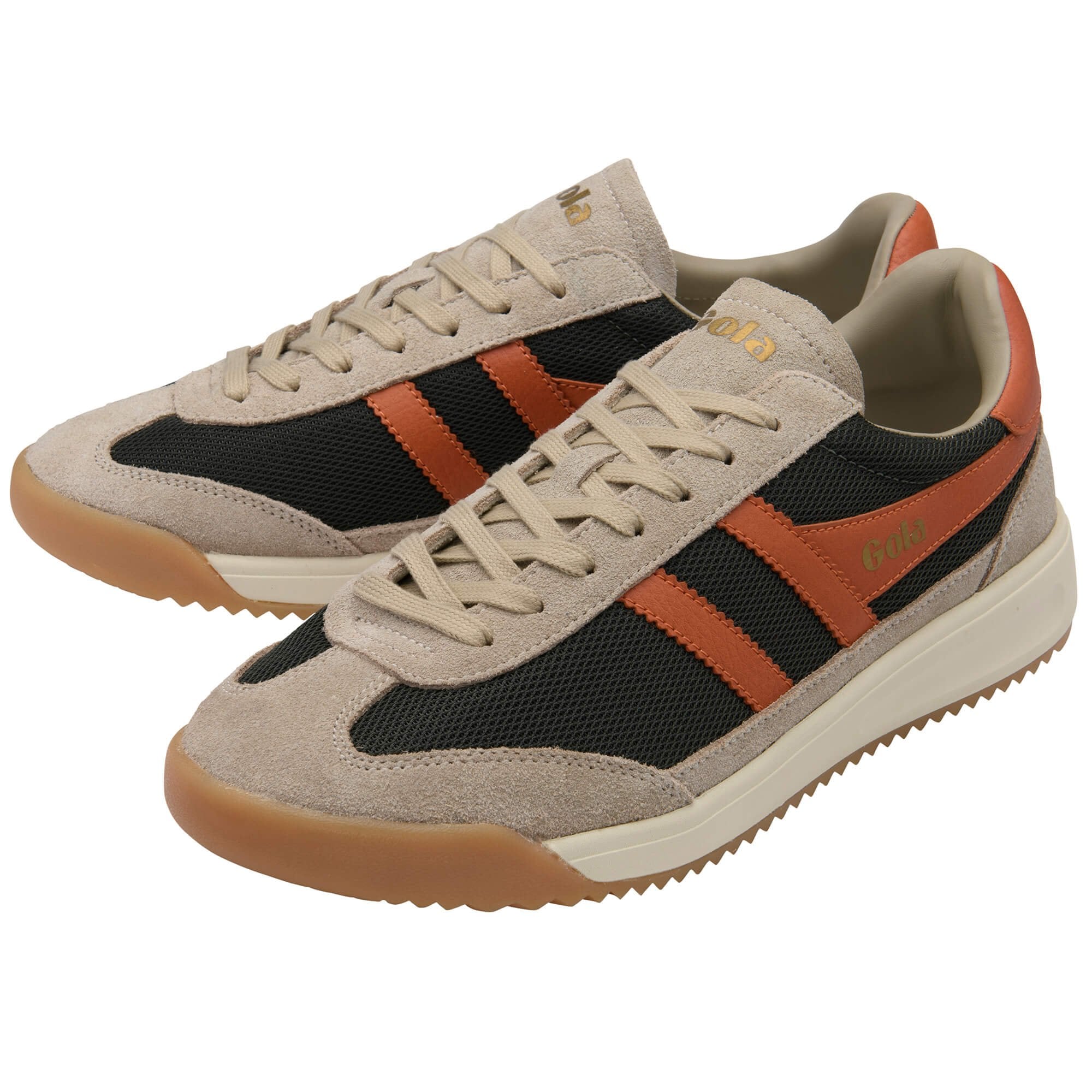 Pair of beige trainers with black and orange stripes on a white background