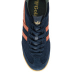 Navy blue trainer with orange stripes on a white background