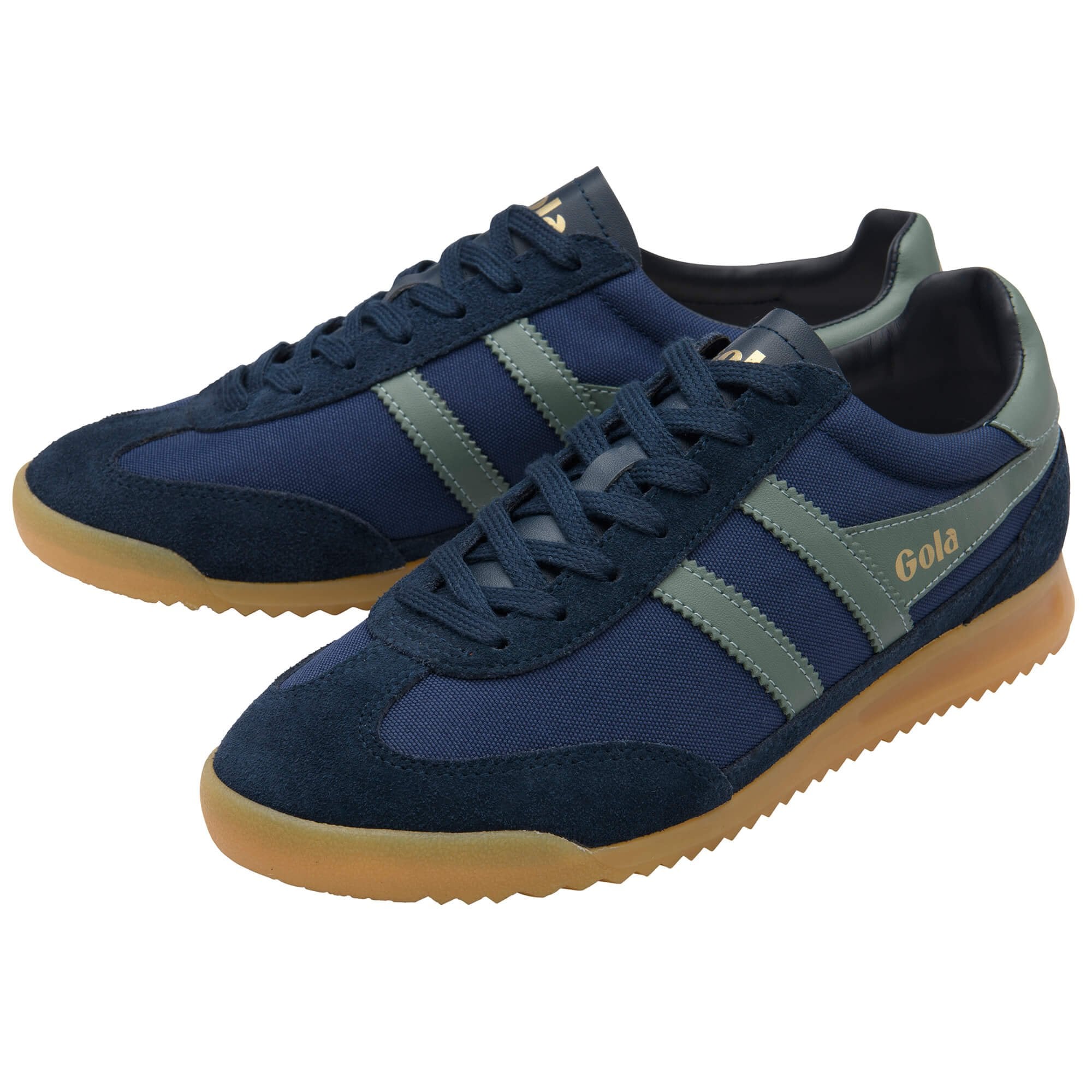 Pair of blue trainers with brown soles on a white background
