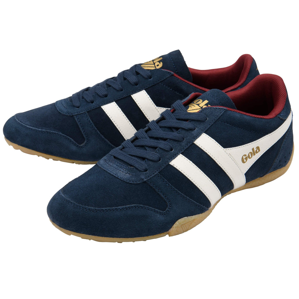 Navy blue trainers with white stripes and red interior on a white background
