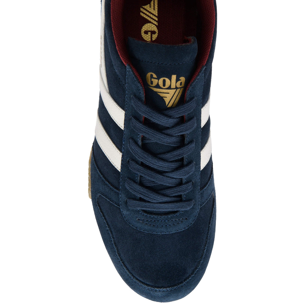 Navy Gola trainer with white stripes and gold Gola logo on the tongue