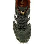 Top-down view of a dark green suede trainer with white stripes and orange lining