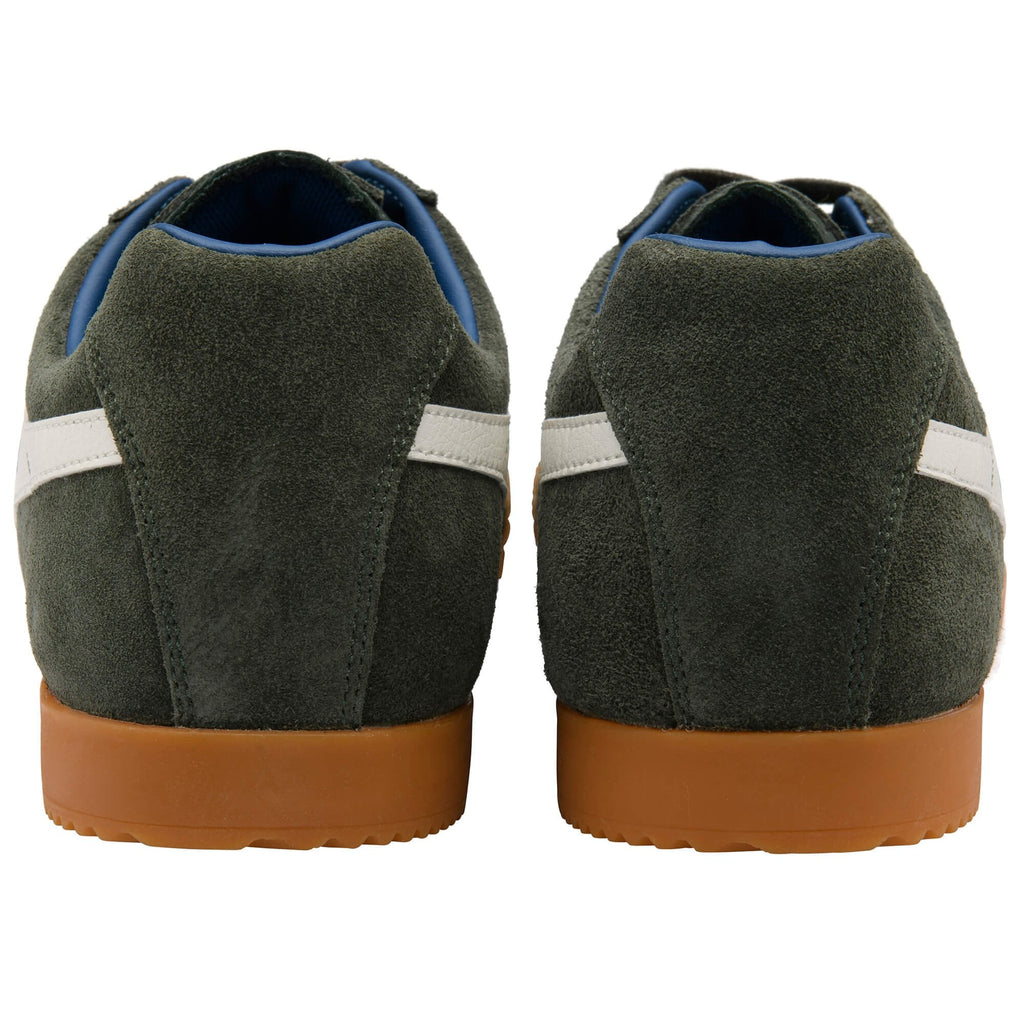 Pair of green suede trainers with brown soles on a white background