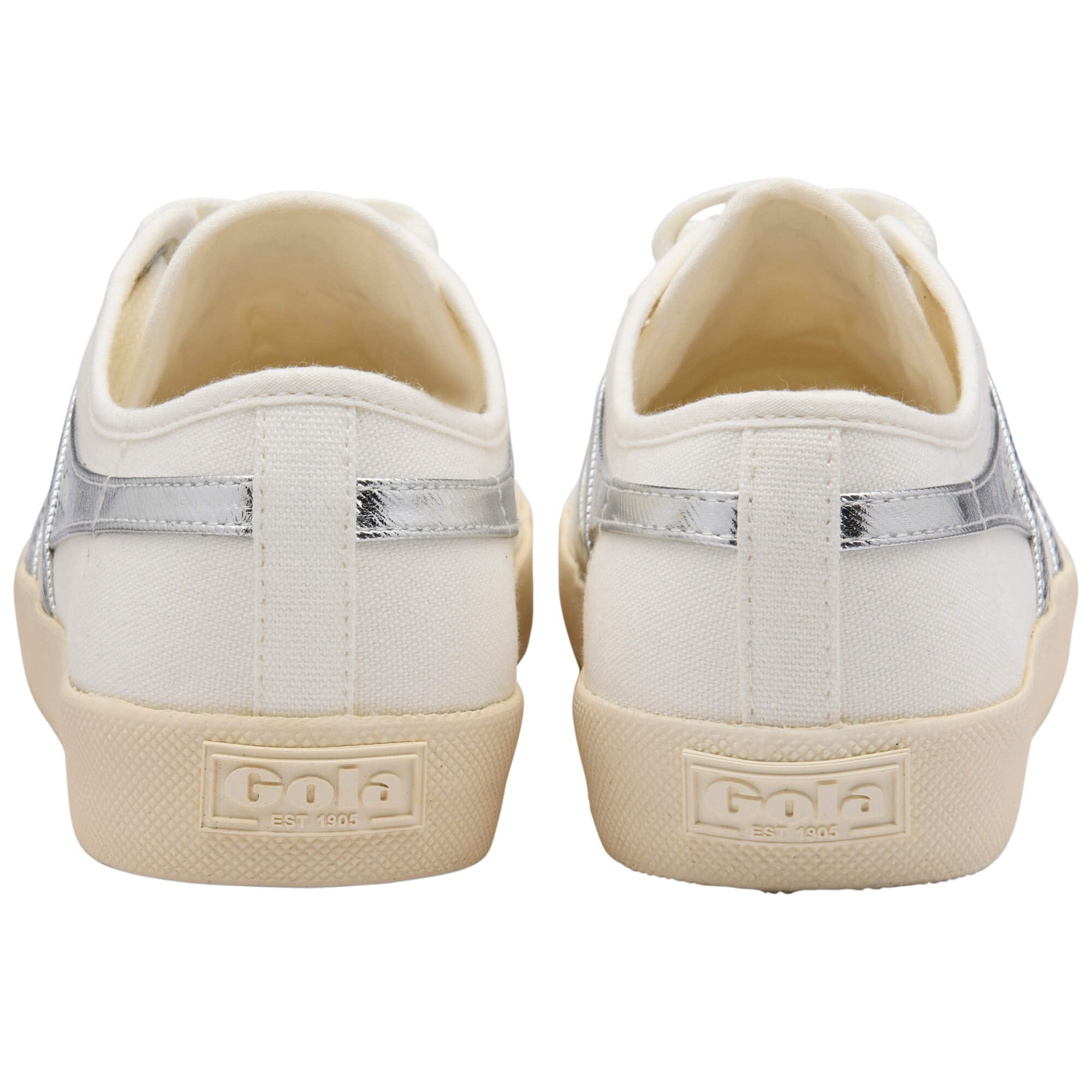 Pair of Gola Coaster trainers in off-white canvas with silver metallic stripes on the sides, rear view on a white background