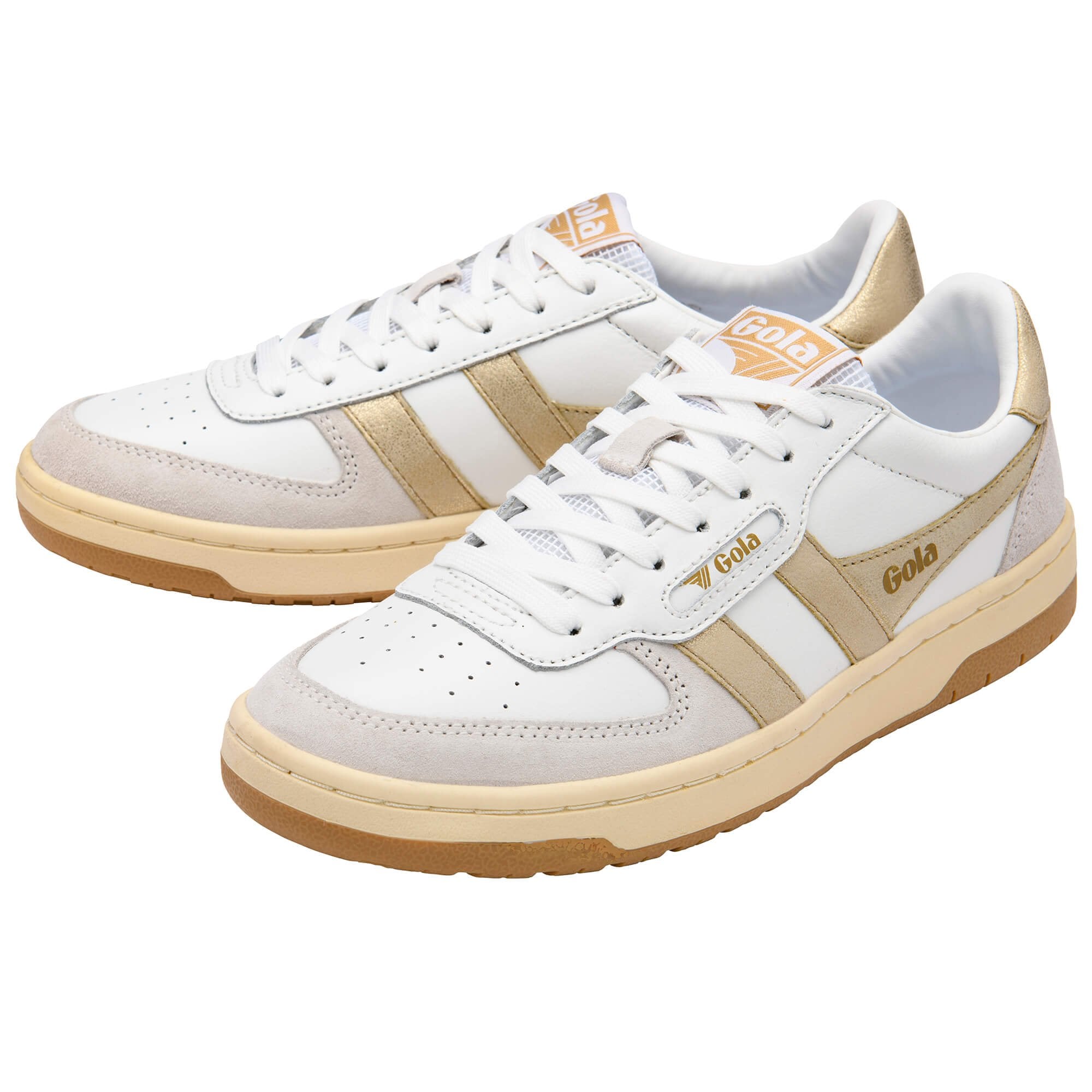 White Gola trainers with gold stripes and heel tab on a white background