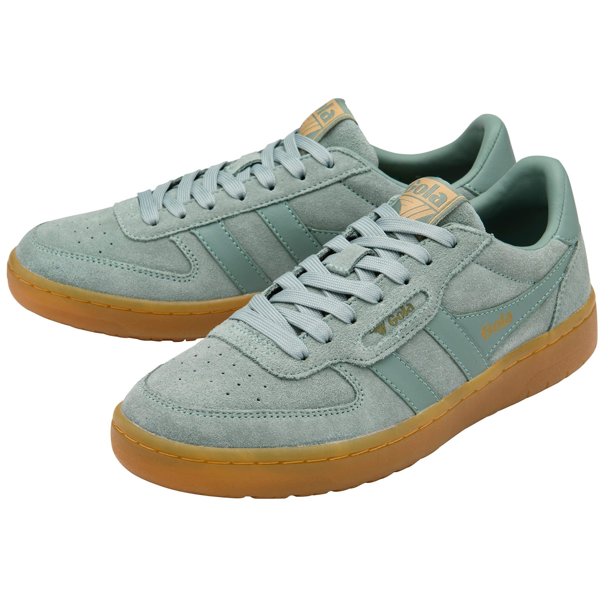 Pair of light green Gola trainers with gum soles on a white background