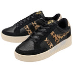 Pair of black Gola trainers with leopard print stripes and gold branding on a white background