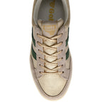 Gola trainer in beige and gold with green stripes and gold laces on a white background