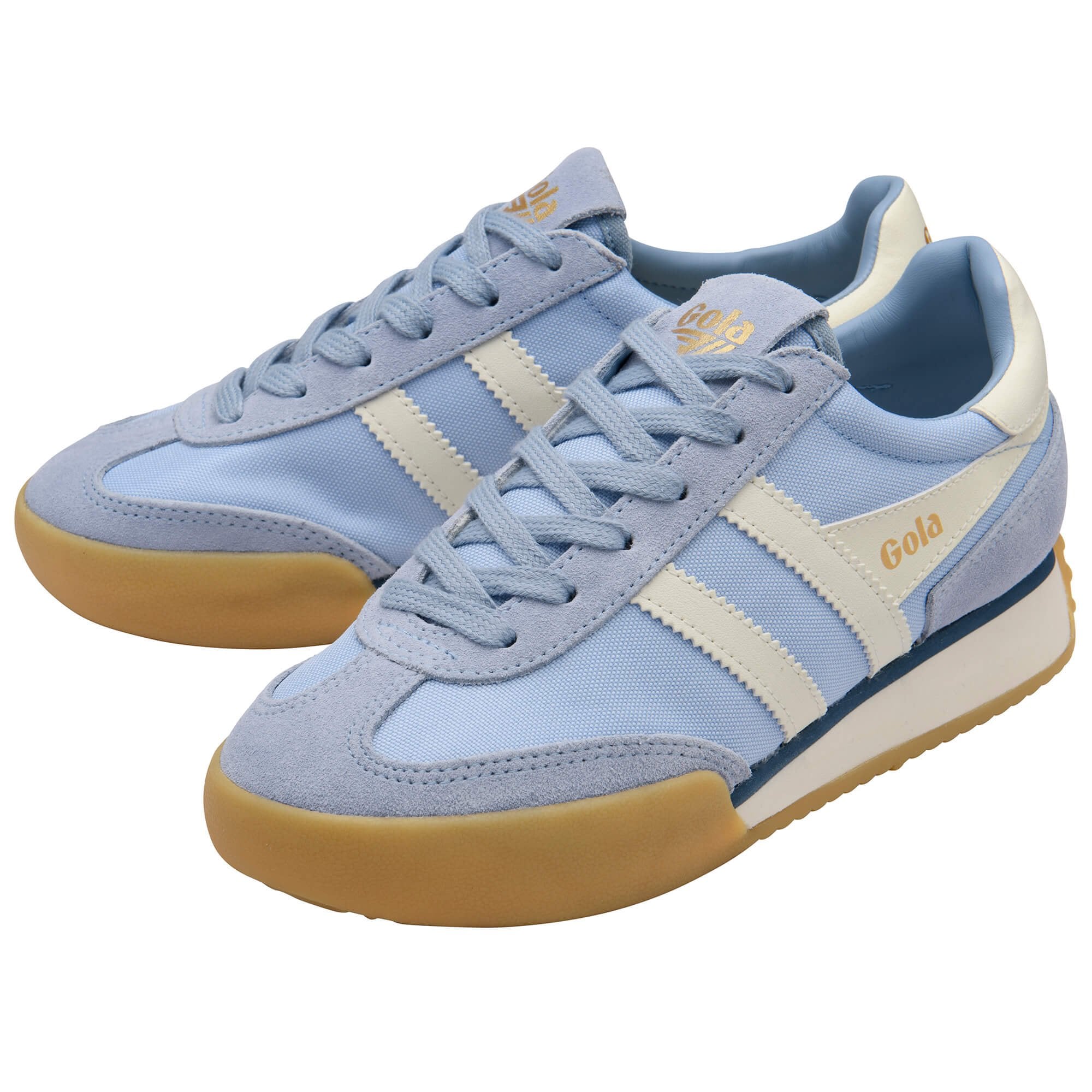 Pair of light blue trainers with beige soles on a white background