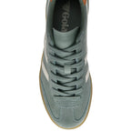 Green Gola trainer with white stripes on a white background