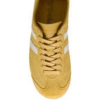 Yellow Gola trainer with white stripes and laces on a white background