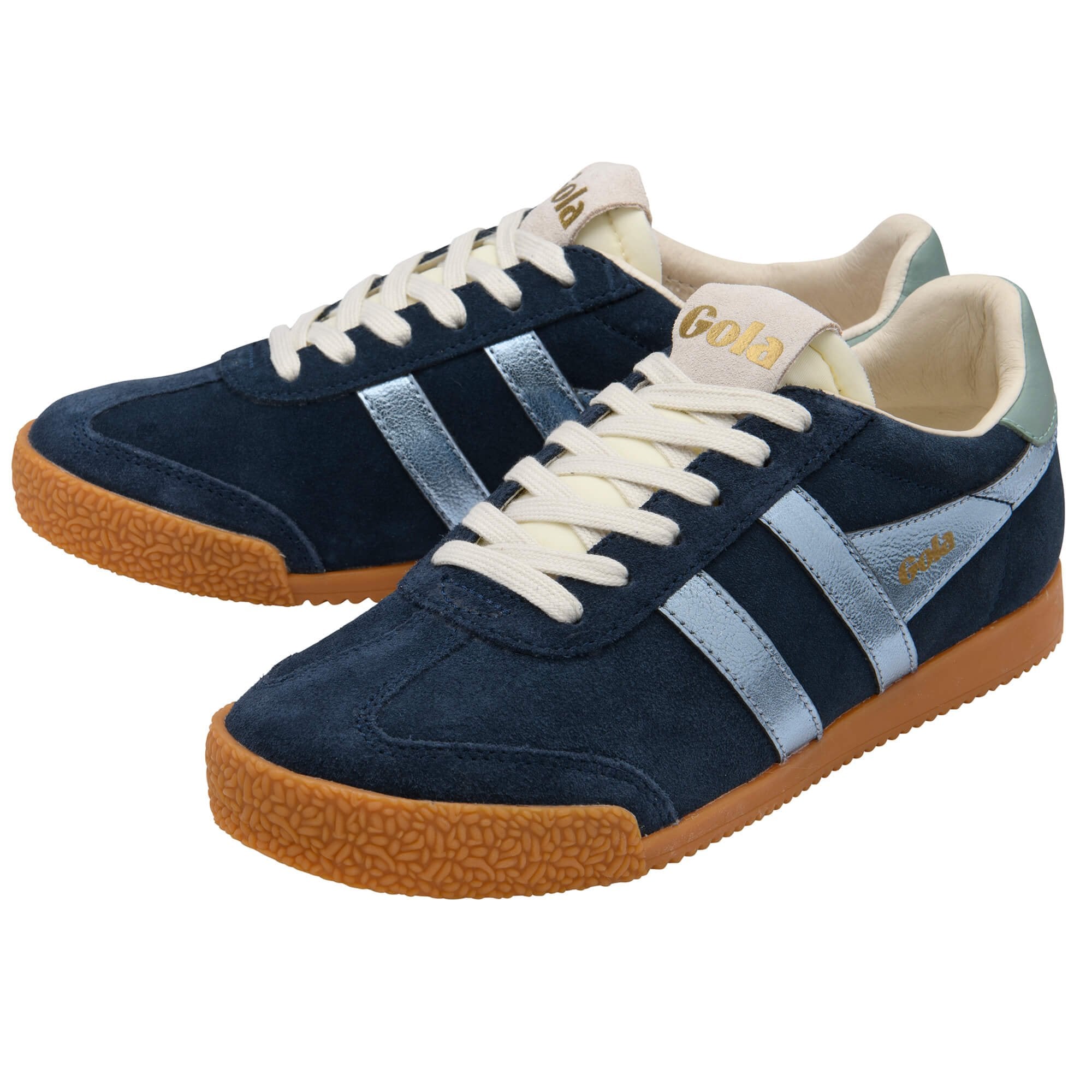 Pair of blue trainers with white laces and brown soles on a white background