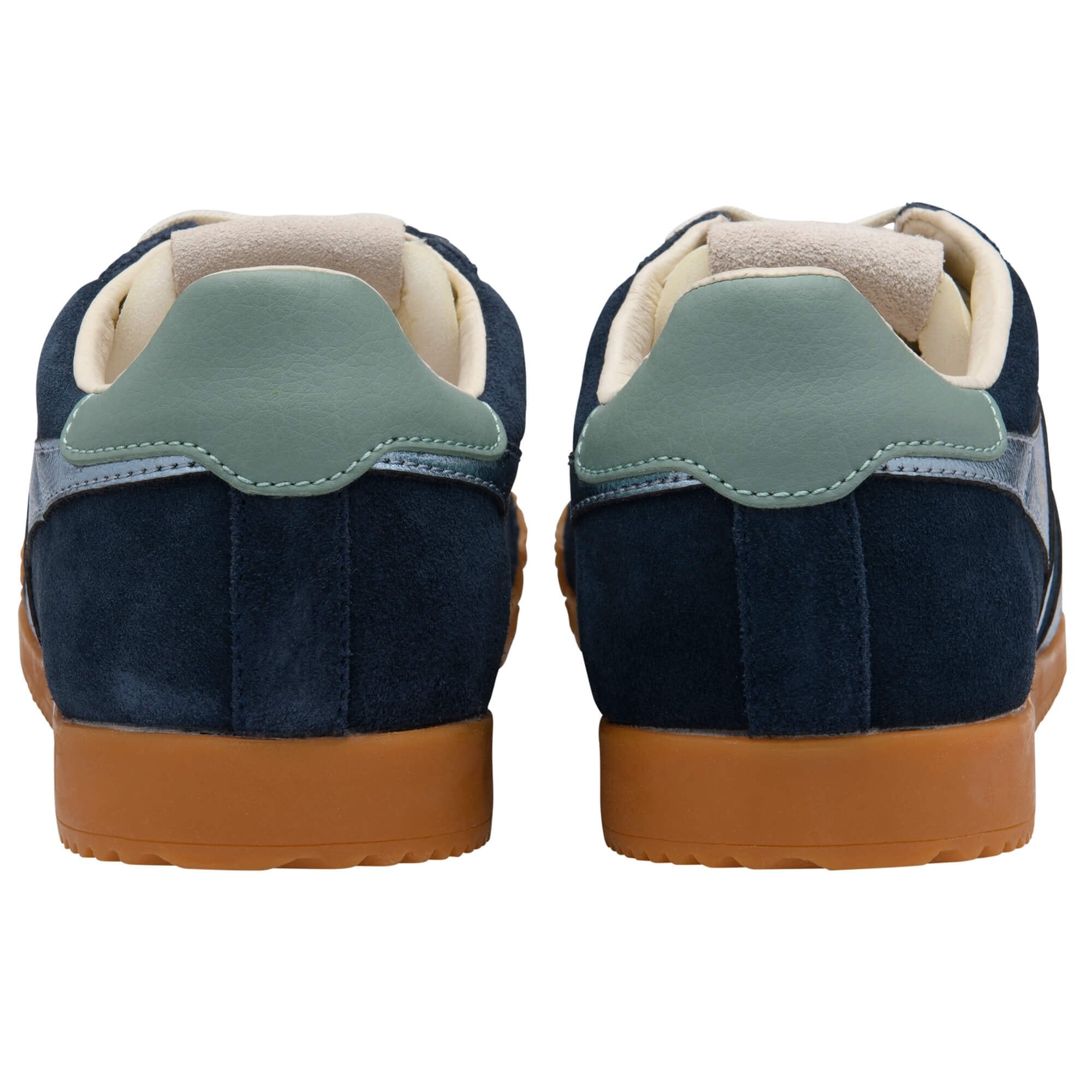 Navy blue trainers with brown soles on a white background