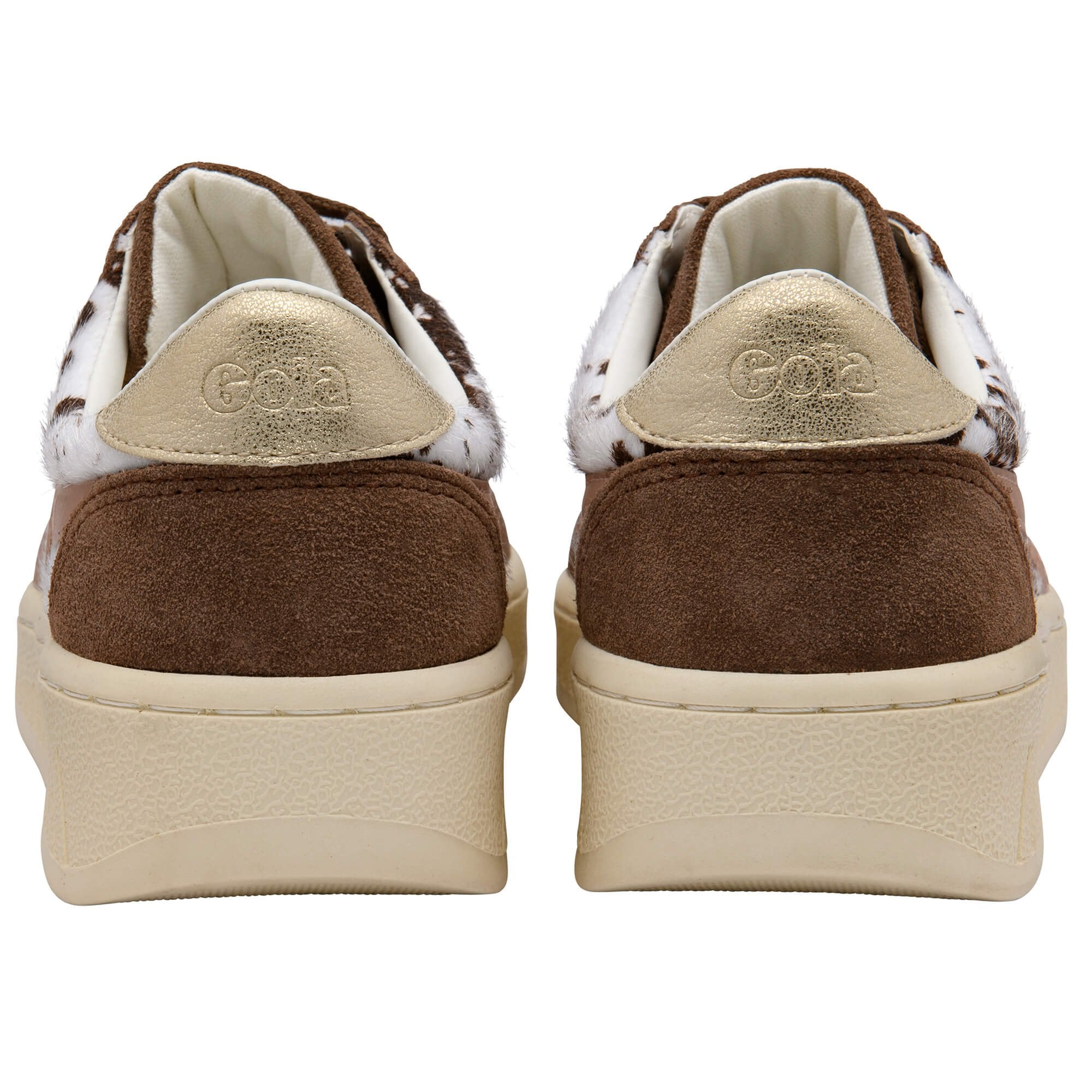 Brown and white Gola trainers on a white background