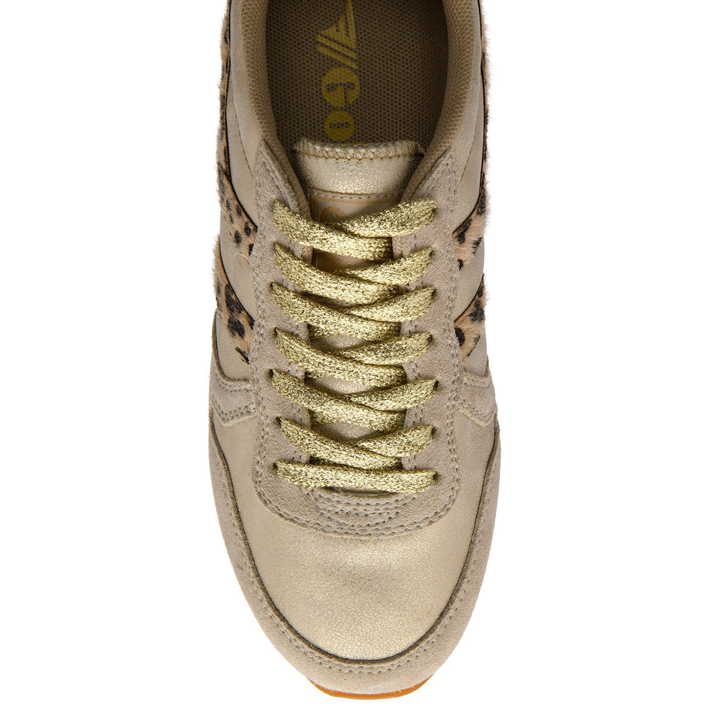 Beige trainer with gold laces on a white background