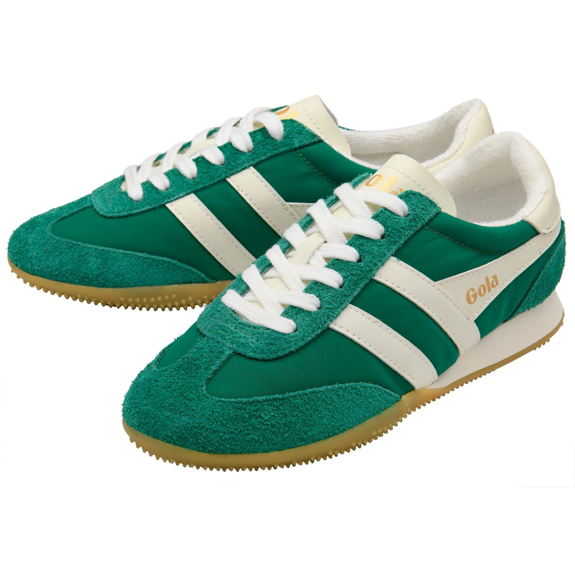 Green trainers with white stripes and laces on a white background