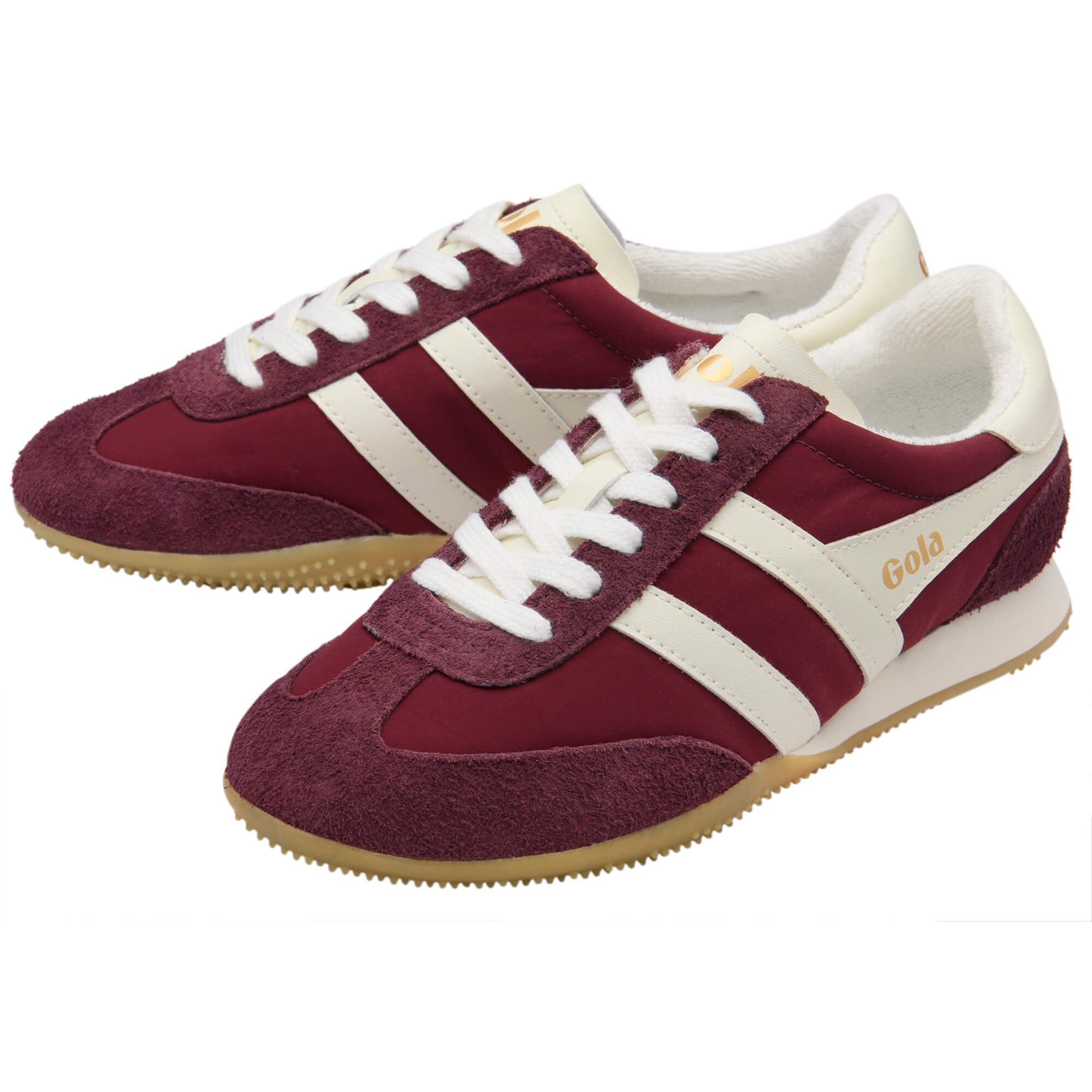 Maroon and white trainers with a Gola logo on a white background