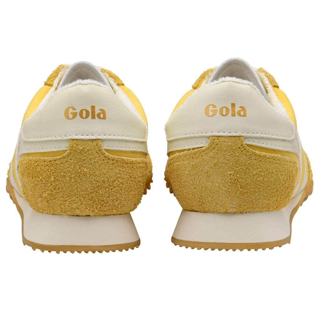 Yellow and white Gola trainers on a white background