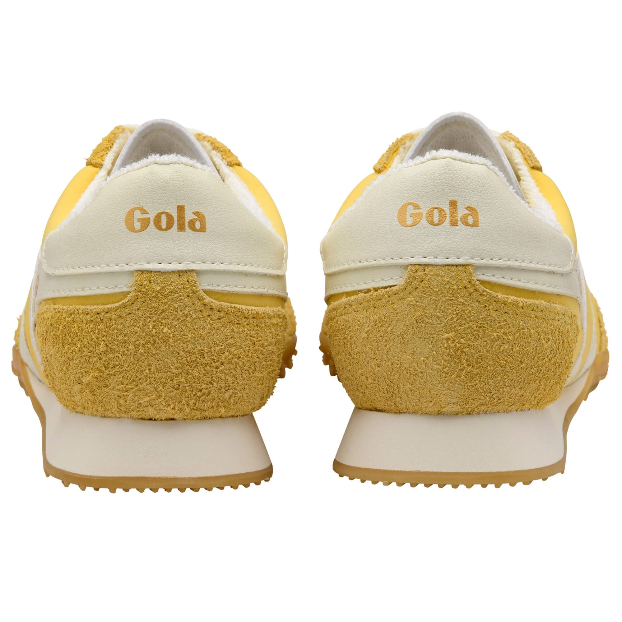 Yellow and white Gola trainers on a white background