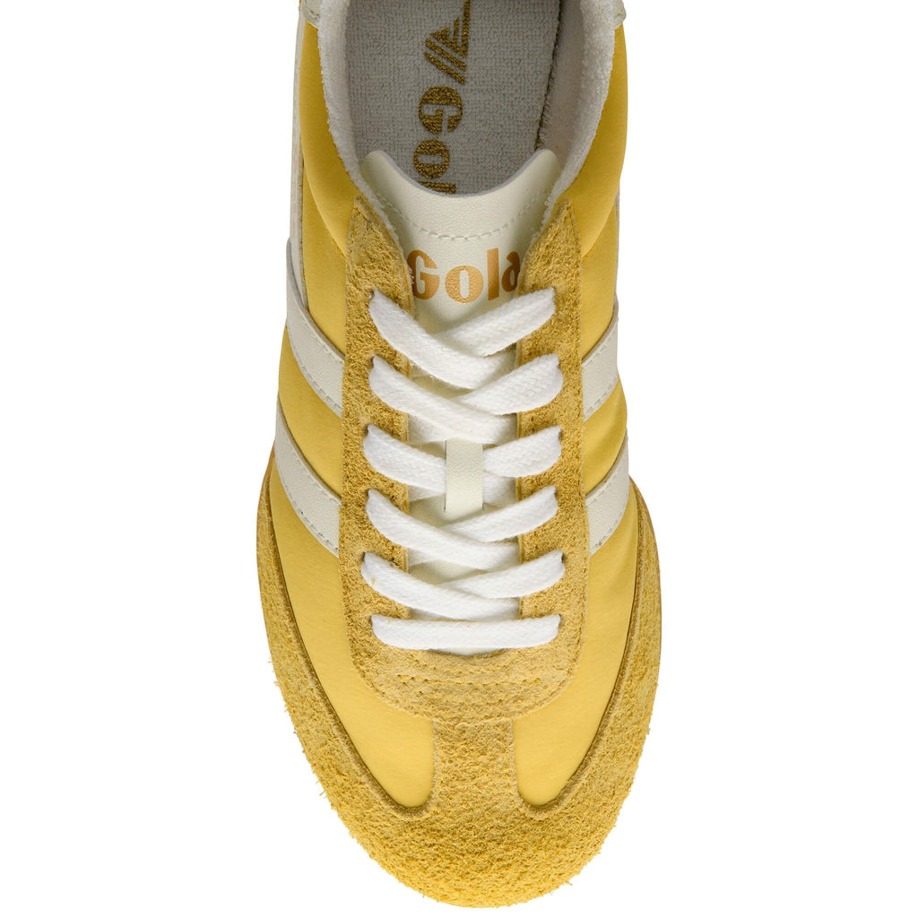 Yellow trainer with white laces on a white background