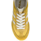 Yellow trainer with white laces on a white background
