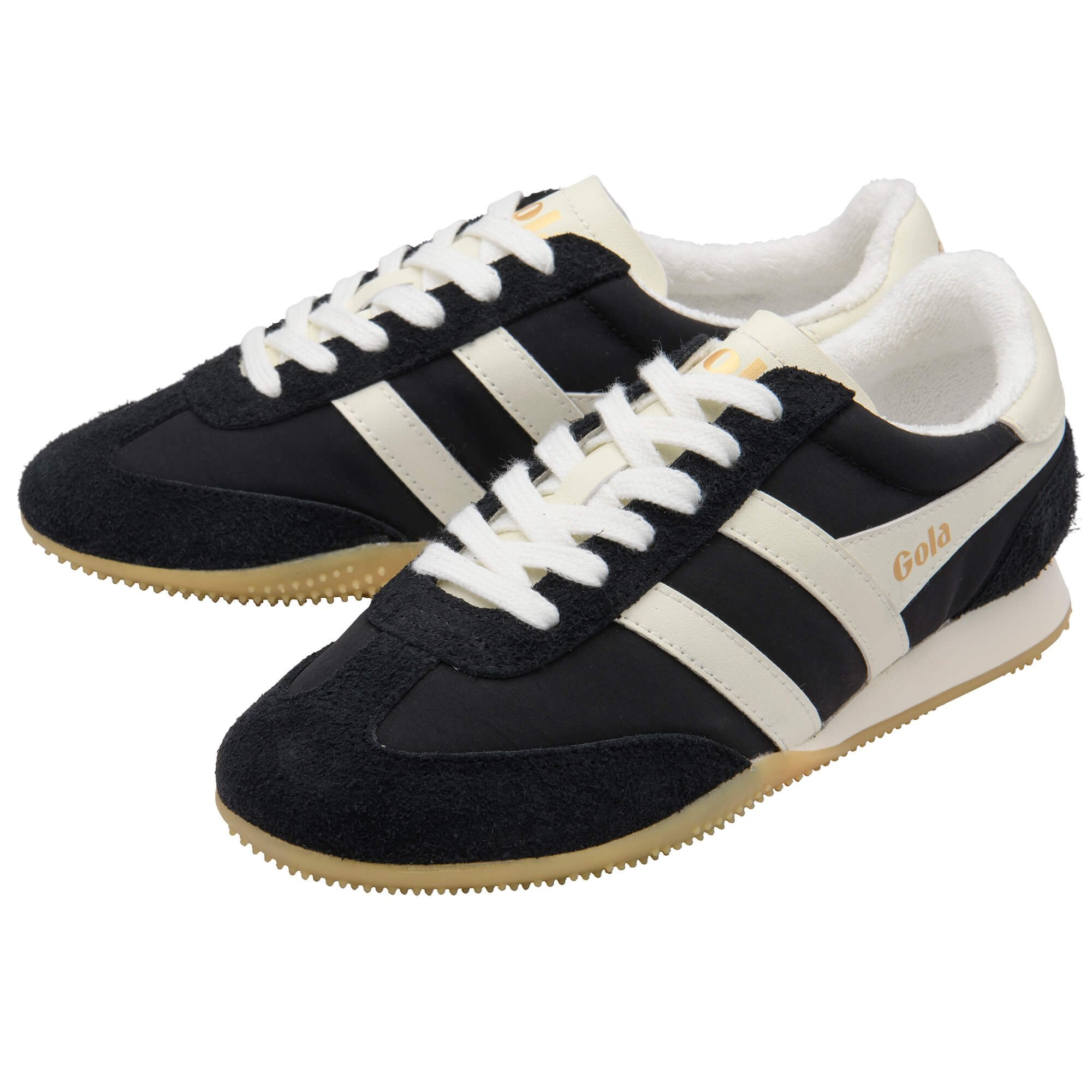 Black and white trainers with 'Gola' branding on a white background