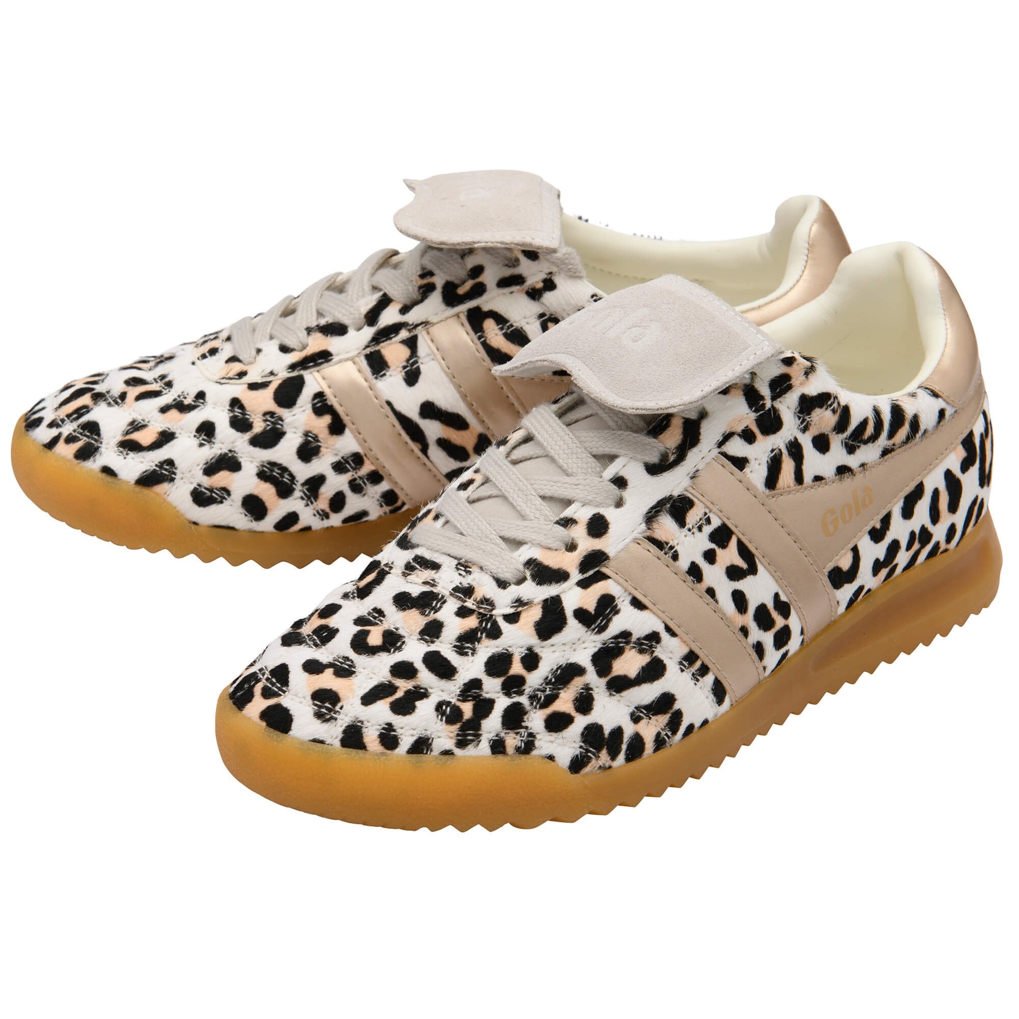 Pair of leopard print trainers with beige soles on a white background