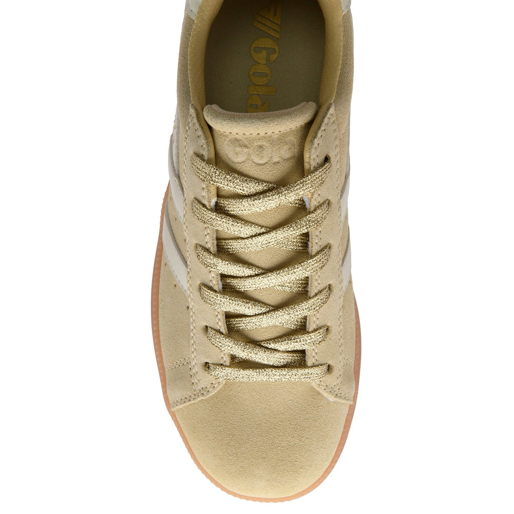 Gold trainer with white laces on a white background