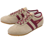 Beige trainers with maroon stripes and 'Gola' branding on a white background