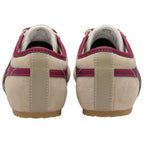 Beige trainers with red accents on a white background