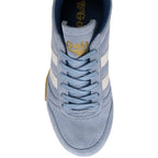 Close up of a light blue Gola trainer with white stripes on a white background