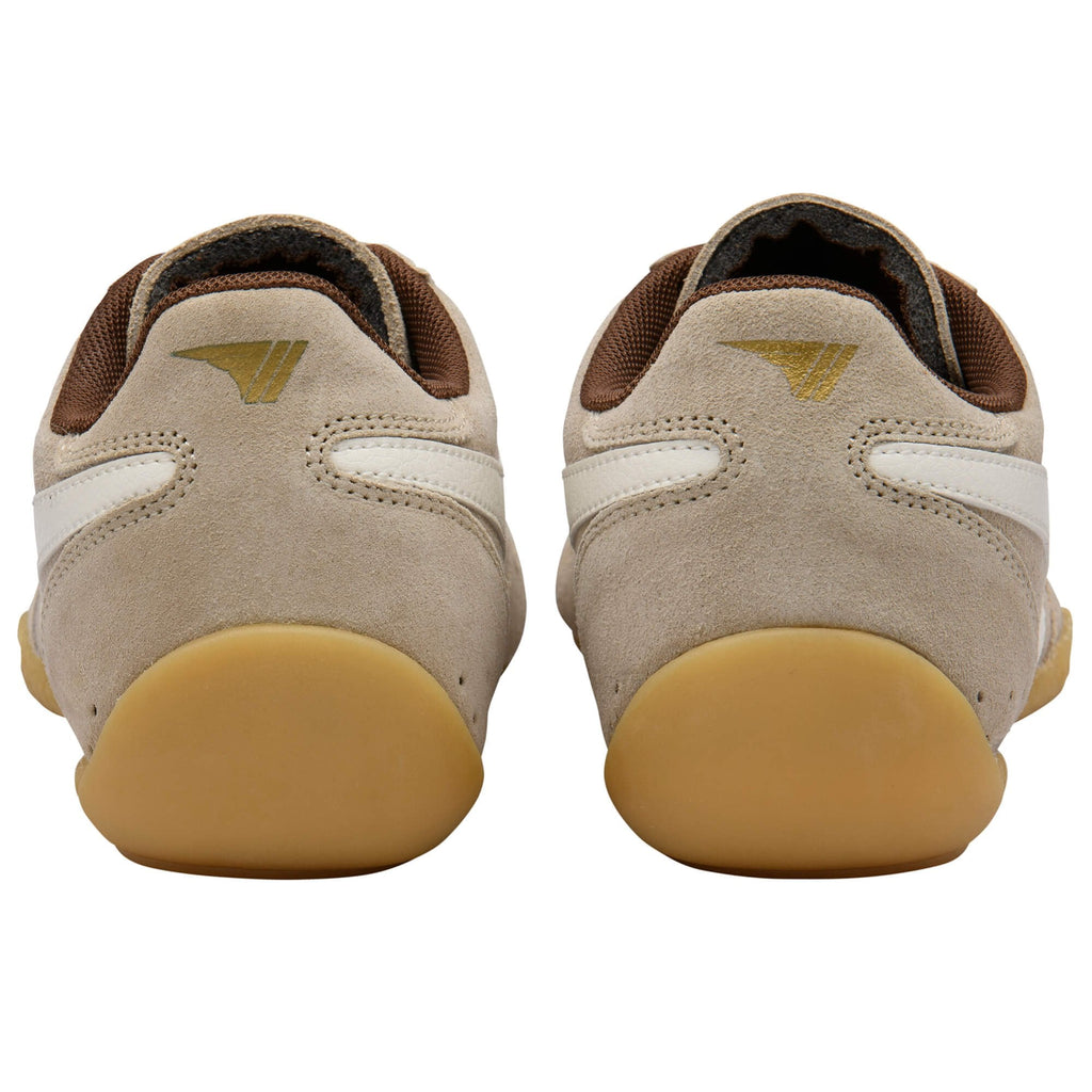 Pair of beige Gola trainers with brown lining on a white background