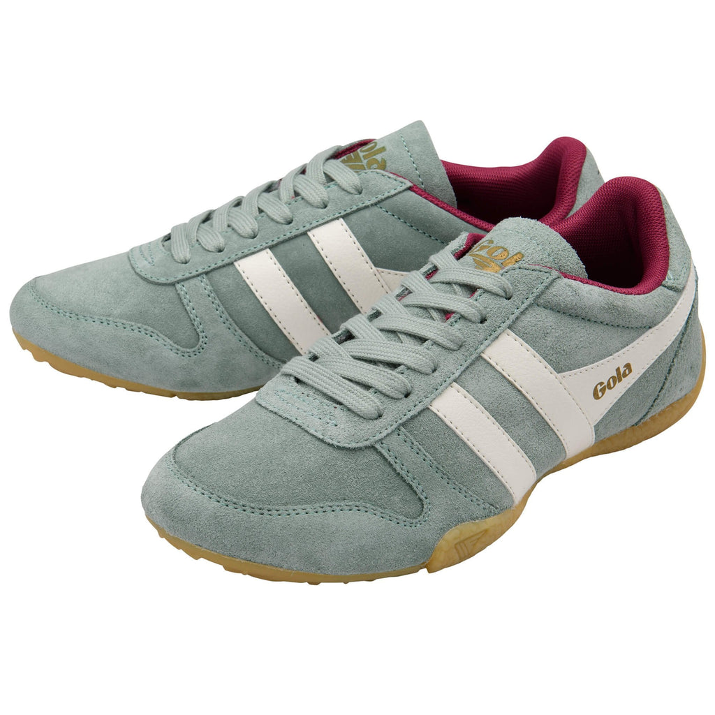 Pair of light green Gola trainers with white stripes and red lining on a white background