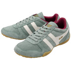 Pair of light green Gola trainers with white stripes and red lining on a white background