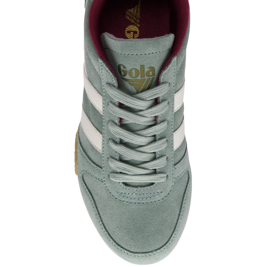 Green Gola trainer with white stripes on a white background