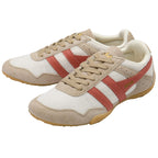 Pair of beige and red trainers on a white background