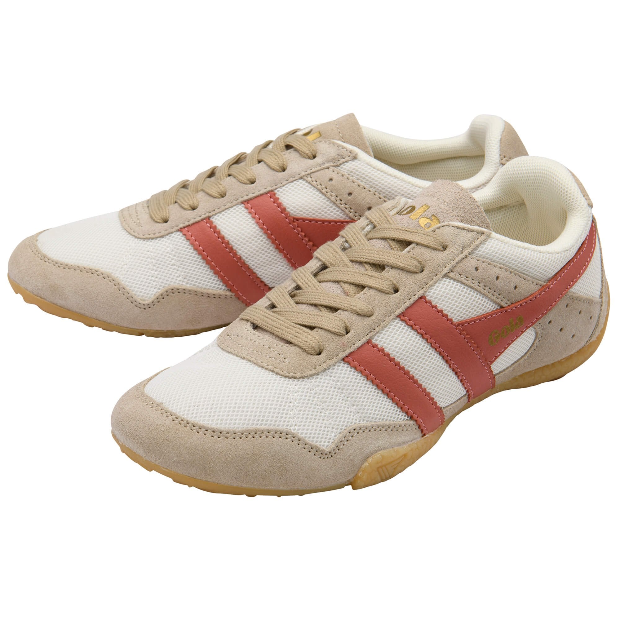 Pair of beige and red trainers on a white background