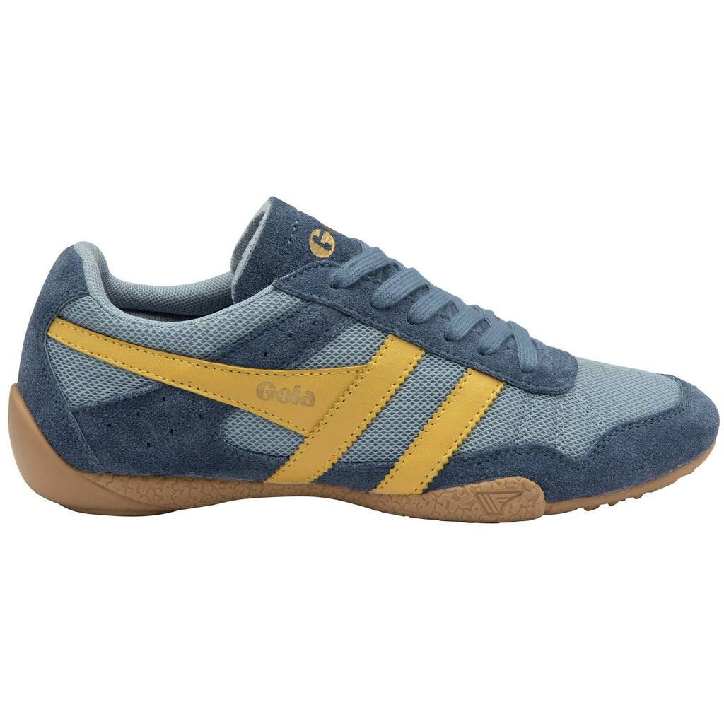 Blue and yellow trainer with brown sole on a white background