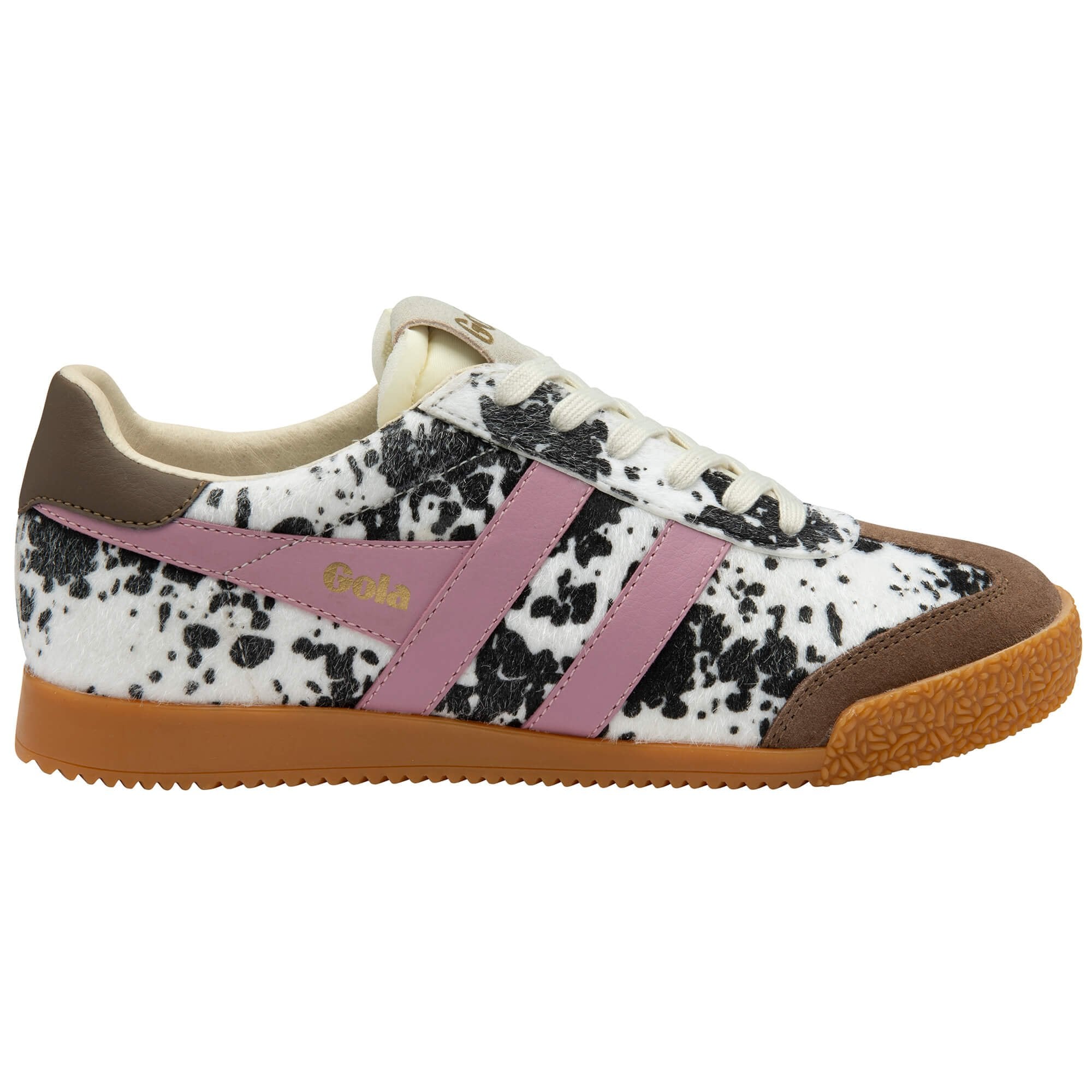 Trainer with black and white animal print pattern, pink accents, and brown sole on a white background