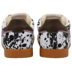 Pair of trainers with animal print upper and gum soles on a white background