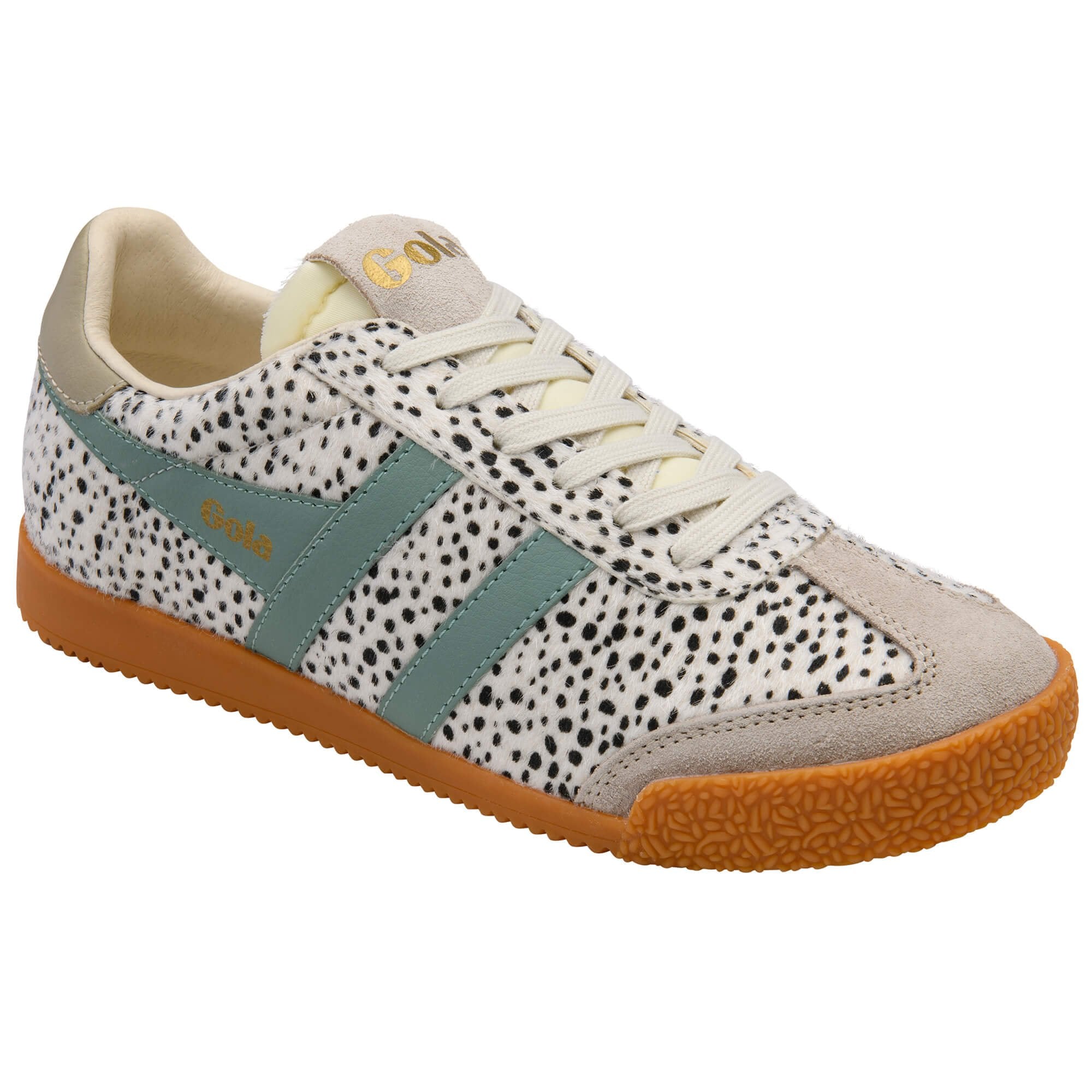 Trainer with spotted pattern and green accents on a white background