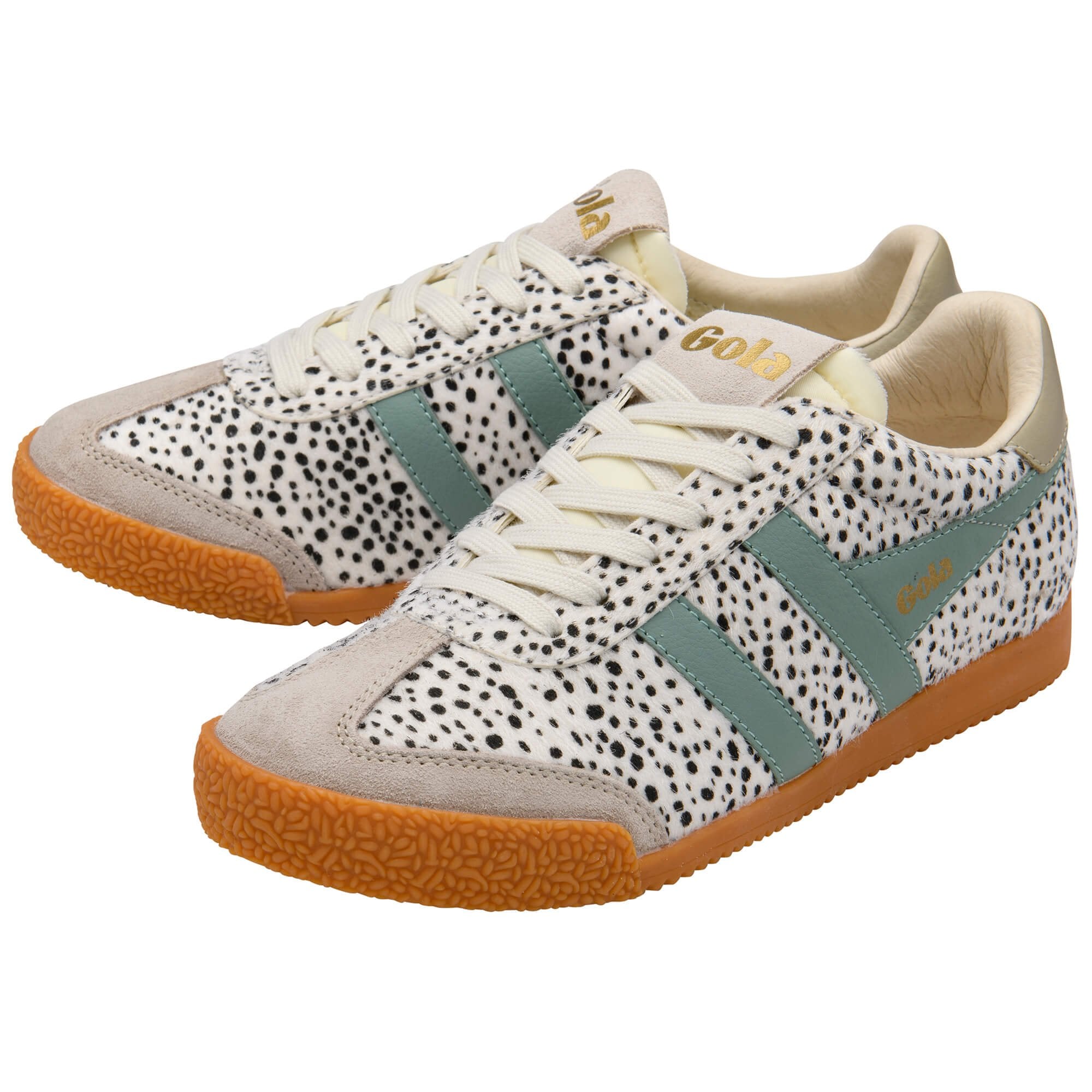 Pair of Gola trainers with white and black animal print, light green stripes, and tan soles
