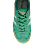 Green Gola trainer with white stripes on a white background