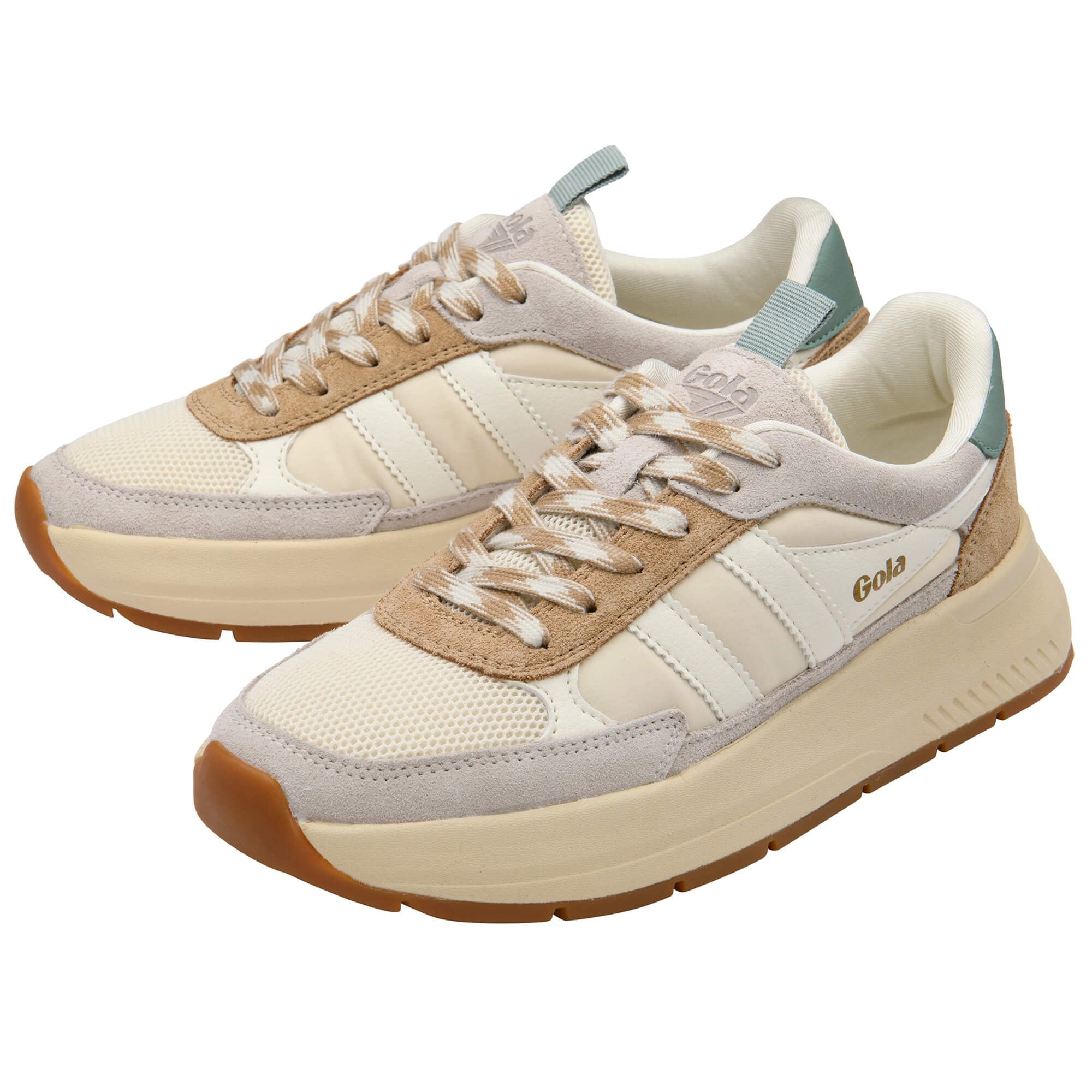 Pair of beige and brown trainers on a white background