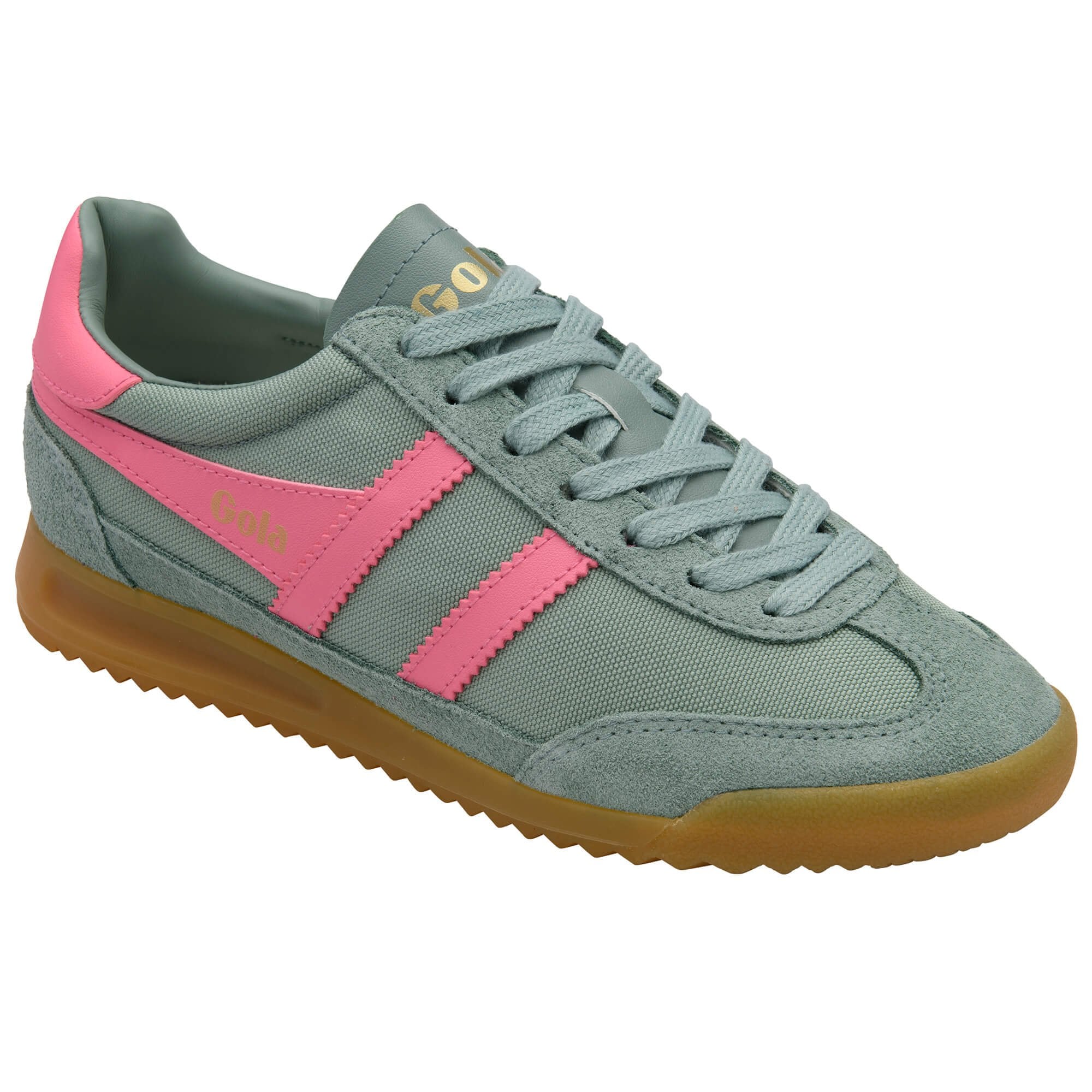 Green and pink trainer with gum sole on a white background
