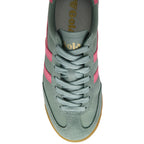 Green Gola trainer with pink stripes and gum sole on a white background